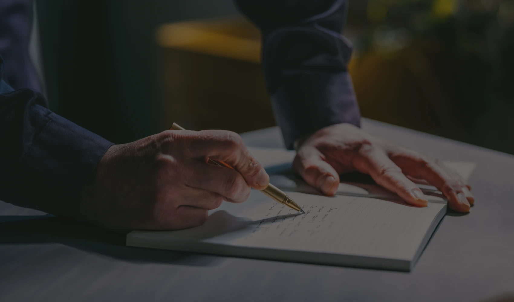 Writing on paper with golden pen